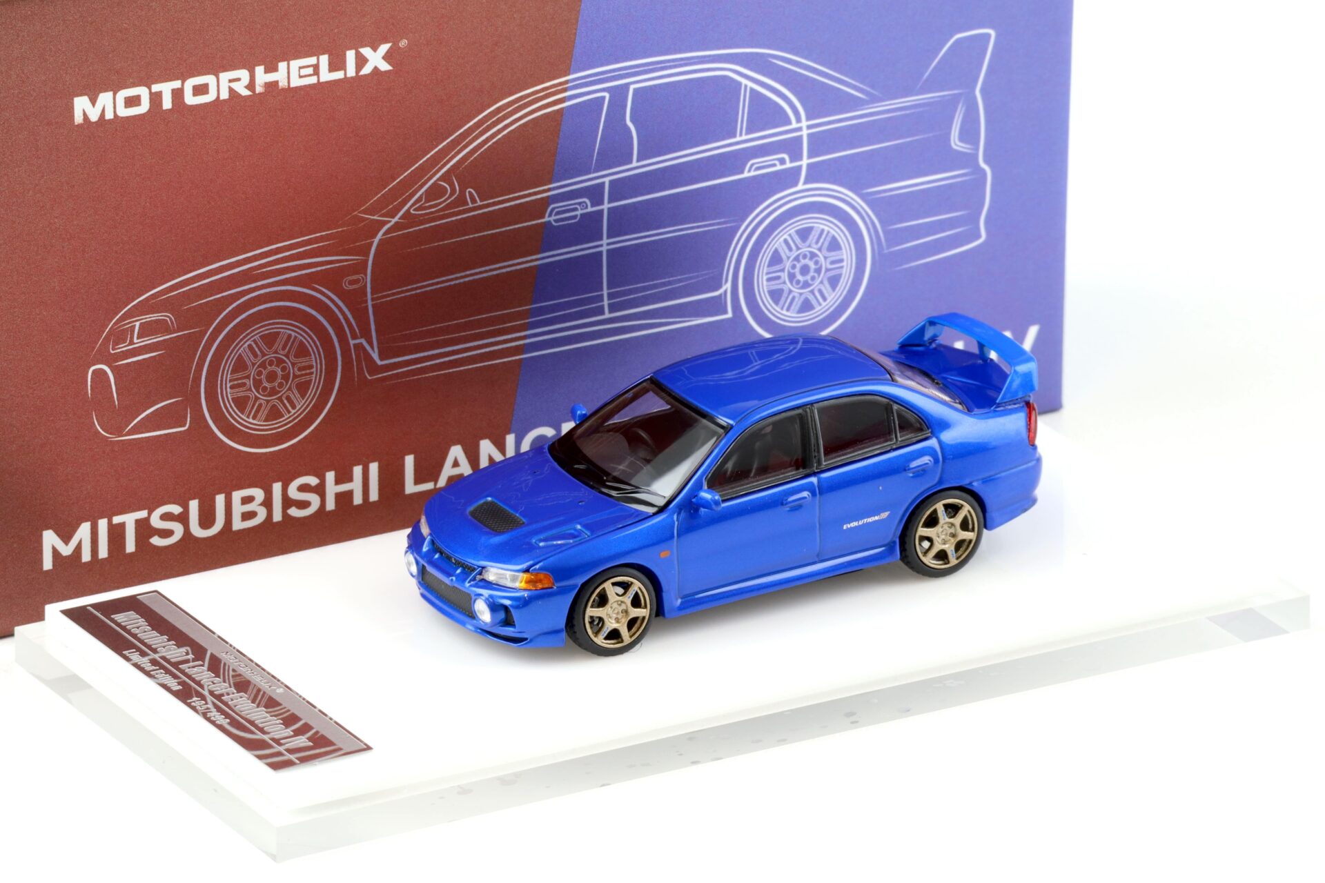 1:64 Motorhelix Mitsubishi Lancer Evolution IV Metal blue + wheels HEC EXPO